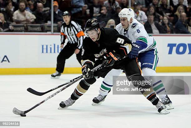 Bobby Ryan of the Anaheim Ducks moves the puck defended by Sami Salo of the Vancouver Canucks in the third period at the Honda Center on April 2,...
