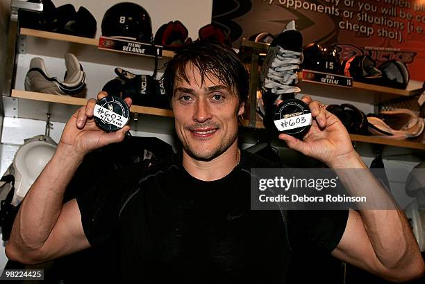 Teemu Selanne of the Anaheim Ducks poses for a photo while holding his pucks for the 602 and 603 goals from the game against the Vancouver Canucks on...