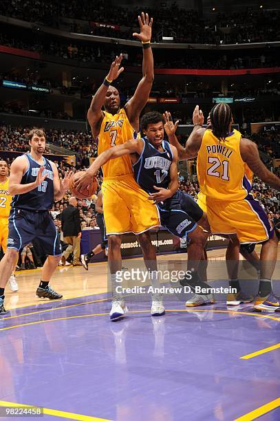 Ronnie Price of the Utah Jazz passes to teammate Mehmet Okur around Lamar Odom of the Los Angeles Lakers during a game at Staples Center on April 2,...