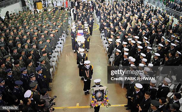 South Korean Navy honor guard carry the coffin of Han Joo-Ho, a 53-year-old Navy warrant officer and a veteran of the Underwater Demolition Team...