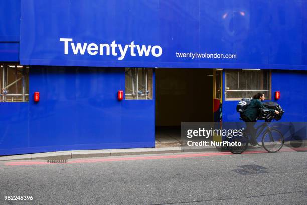 Man rides a bicycle past the under-construction 22 Bishopsgate tower, marketed as Twentytwo, continues to rise to its full height of 62 storeys in...