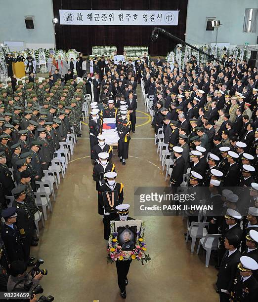 South Korean Navy honor guard carry the coffin of Han Joo-Ho, a 53-year-old Navy warrant officer and a veteran of the Underwater Demolition Team...