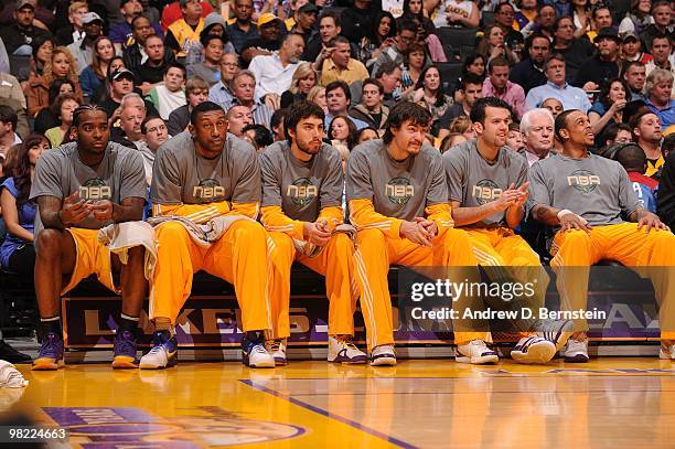 Josh Powell, DJ Mbenga, Sasha Vujacic, Adam Morrison, Jordan Farmar, and Shannon Brown of the Los Angeles Lakers sit on the bench during a game...