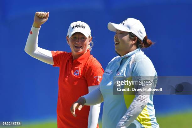 Stacy Lewis of the United States and Shanshan Feng of China laugh while walking to the 17th hole during the second round of the Walmart NW Arkansas...