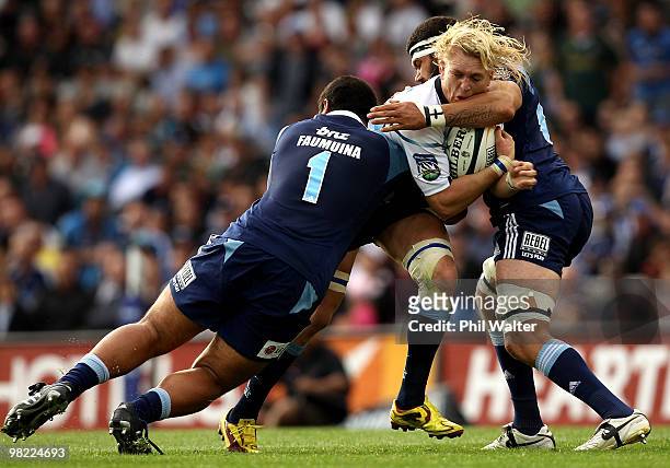 Dewald Potgieter of the Bulls is tackled by John Afoa of the Blues during the round eight Super 14 match between the Blues and the Bulls at Eden Park...
