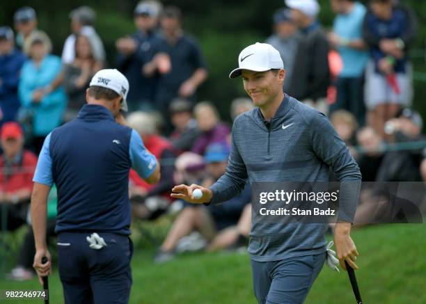 Russell Henley acknowledges the gallery on the sixth hole during the third round of the Travelers Championship at TPC River Highlands on June 23,...