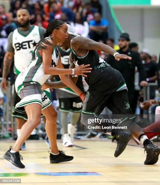 Erica Ash and Larry 'Bone Collector' Williams play basketball at the Celebrity Basketball Game Sponsored By Sprite during the 2018 BET Experience at...