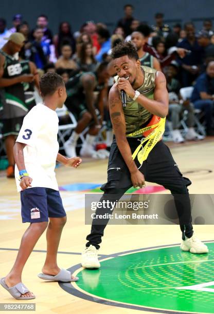 Desiigner serenades an audience member at the Celebrity Basketball Game Sponsored By Sprite during the 2018 BET Experience at Los Angeles Convention...