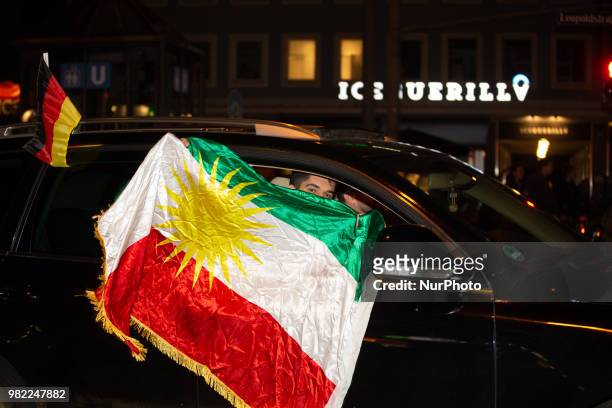 Fans celebrating with a flag of Iraqi Kurdistan in the streets of Munich. German fans watched the match Germany Sweden 2-1, which Germany won in the...