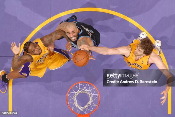 Carlos Boozer of the Utah Jazz reaches for a rebound between Josh Powell and Pau Gasol of the Los Angeles Lakers at Staples Center on April 2, 2010...