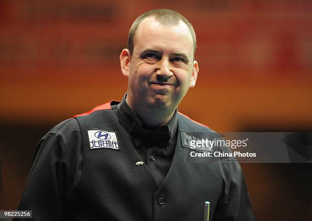 Mark Williams of Wales reacts during his quarterfinal match against Marco Fu of Hong Kong during the 5th day of 2010 World Snooker China Open at...