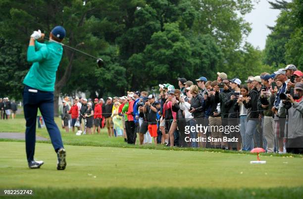 Fans line up to watch Jordan Spieth hitting a tee shot on the seventh hole during the third round of the Travelers Championship at TPC River...