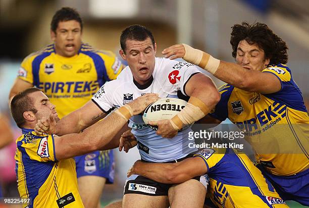 Paul Gallen of the Sharks is wrapped up by the defence during the round four NRL match between the Cronulla Sharks and the Parramatta Eels at Toyota...