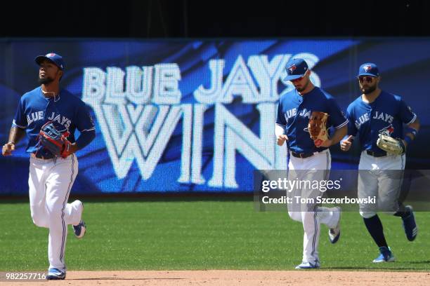 Teoscar Hernandez of the Toronto Blue Jays and Randal Grichuk and Kevin Pillar jog off the field after their victory during MLB game action against...