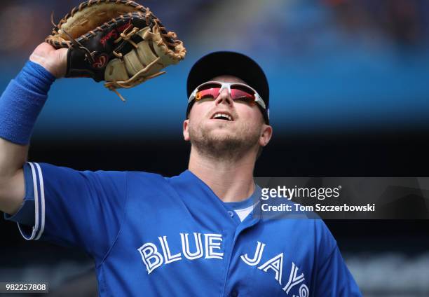 Justin Smoak of the Toronto Blue Jays catches a pop out in the eighth inning during MLB game action against the Atlanta Braves at Rogers Centre on...