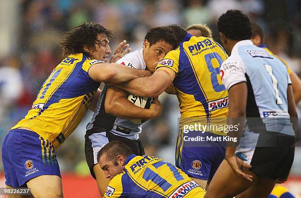 Anthony Tupou of the Sharks is wrapped up by the defence during the round four NRL match between the Cronulla Sharks and the Parramatta Eels at...