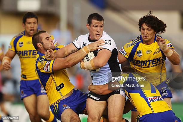 Paul Gallen of the Sharks is wrapped up by the defence during the round four NRL match between the Cronulla Sharks and the Parramatta Eels at Toyota...