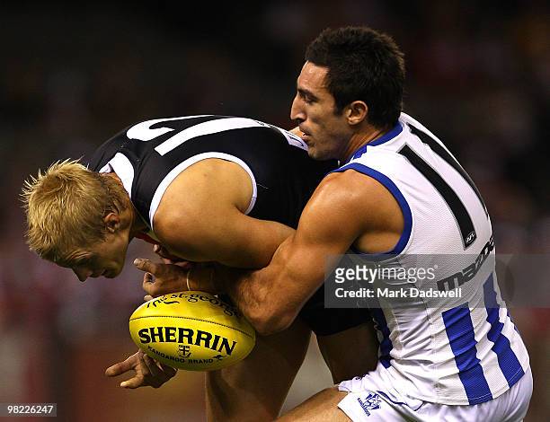 Nick Riewoldt of the Saints is tackled by Michael Firrito of the Kangaroos during the round two AFL match between the St Kilda Saints and the North...
