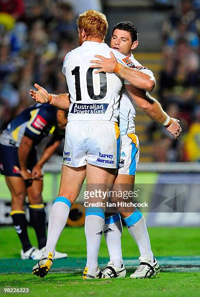 Mark Minichiello of the Titans is congratulated by Brad Meyers of the Titans the first try of the match during the round four NRL match between the...