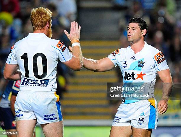 Mark Minichiello of the Titans is congratulated by Brad Meyers of the Titans the first try of the match during the round four NRL match between the...