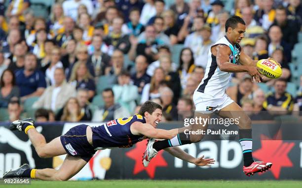 Danyle Pearce of the Power evades a tackle by Patrick McGinnity of the Eagles during the round two AFL match between the West Coast Eagles and Port...