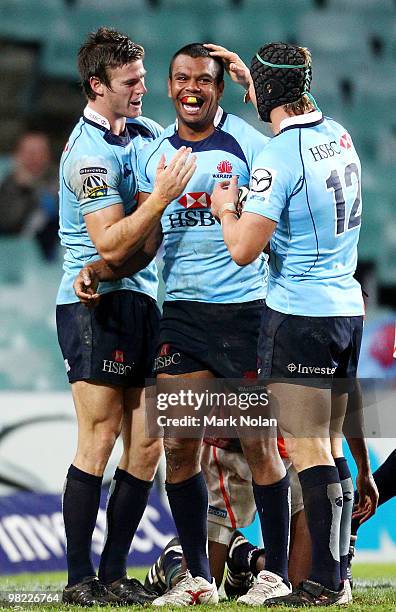 Kurtley Beale of the Waratahs celebrates his try with Rob Horne and Berrick Barnes during the round eight Super 14 match between the Waratahs and the...