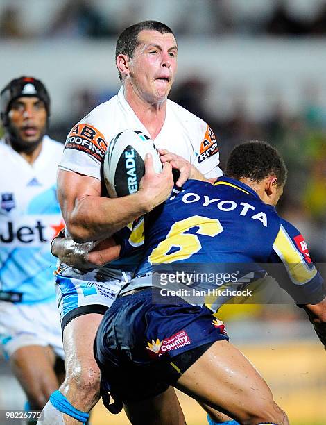Greg Bird of the Titans is tackled by Ray Thompson of the Cowboys during the round four NRL match between the North Queensland Cowboys and the Gold...