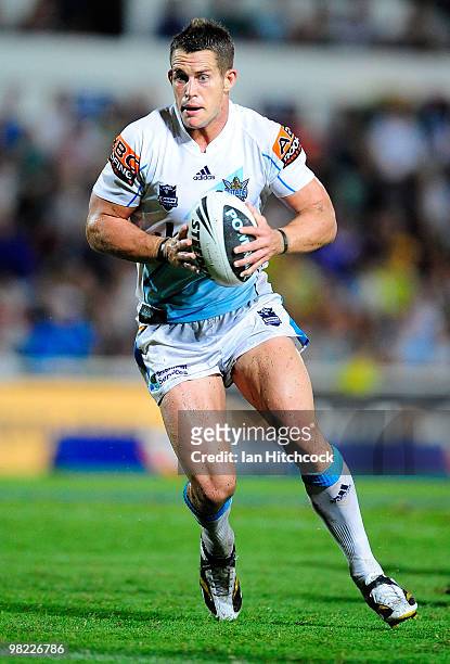 Ashley Harrison of the Titans runs the ball during the round four NRL match between the North Queensland Cowboys and the Gold Coast Titans at Dairy...