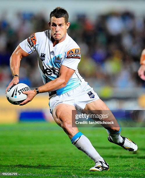 Ashley Harrison of the Titans runs the ball during the round four NRL match between the North Queensland Cowboys and the Gold Coast Titans at Dairy...