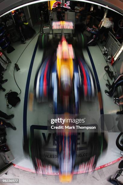 Sebastian Vettel of Germany and Red Bull Racing exits his team garage during qualifying for the Malaysian Formula One Grand Prix at the Sepang...