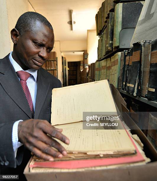 National Archives of Senegal's director Babacar Ndiaye displays a document on March 22, 2010 in the basement of the Government building in Dakar,...