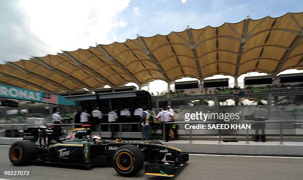 Lotus-Cosworth driver Jarno Trulli of Italy powers his car at the pit lane during third practice session for Formula One's Malaysian Grand Prix in...