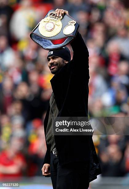 Boxer David Haye shows off his WBA Heavyweight champion's belt to the crowd prior to the Barclays Premier League match between Manchester United and...