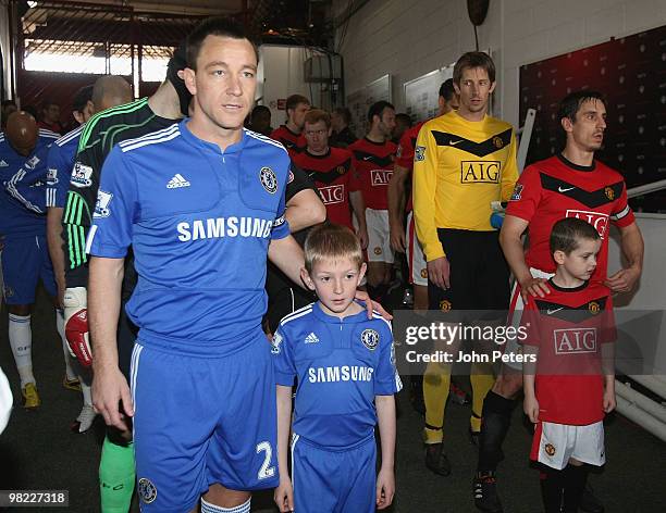 Gary Neville of Manchester United and John Terry of Chelsea prepare to lead their teams out ahead of the FA Barclays Premier League match between...