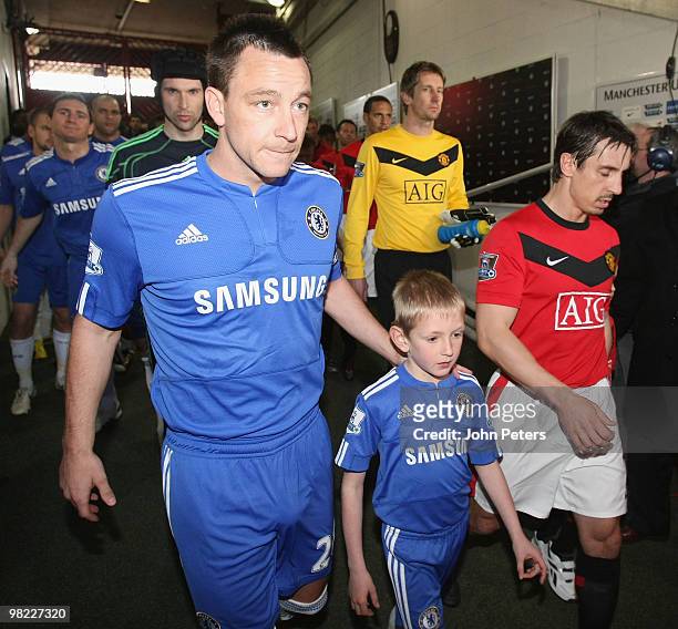 Gary Neville of Manchester United and John Terry of Chelsea prepare to lead their teams out ahead of the FA Barclays Premier League match between...