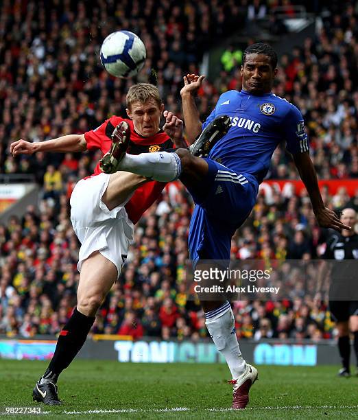 Darren Fletcher of Manchester United tangles with Florent Malouda of Chelsea during the Barclays Premier League match between Manchester United and...