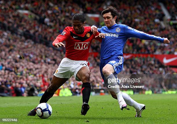 Antonio Valencia of Manchester United is challenged by Yuri Zhirkov of Chelsea during the Barclays Premier League match between Manchester United and...