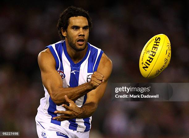 Daniel Wells of the Kangaroos handballs during the round two AFL match between the St Kilda Saints and the North Melbourne Kangaroos at Etihad...