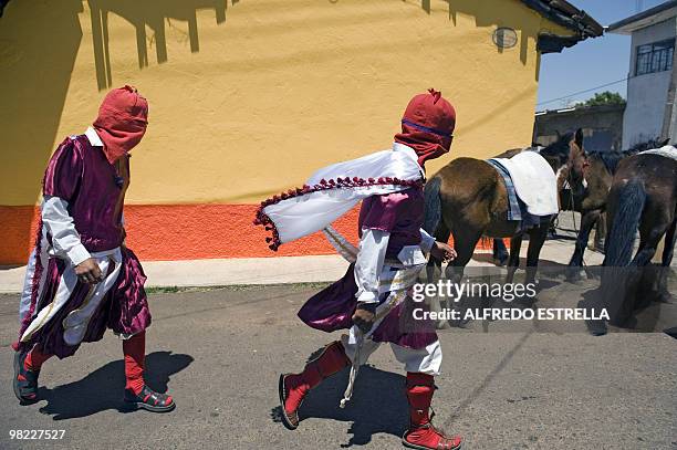 Actors perform the Via Crucis on April 1, 2010 in Tzintzuntzan community in Morelia, Mexico. The actors are called "Spies" and ride around the...