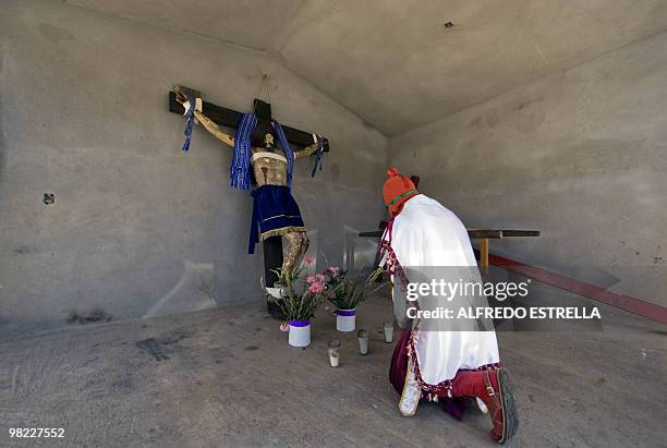 An actor prays before performing the Via Crucis on April 1, 2010 in Tzintzuntzan community in Morelia, Mexico. The actors are called "Espias" , and...