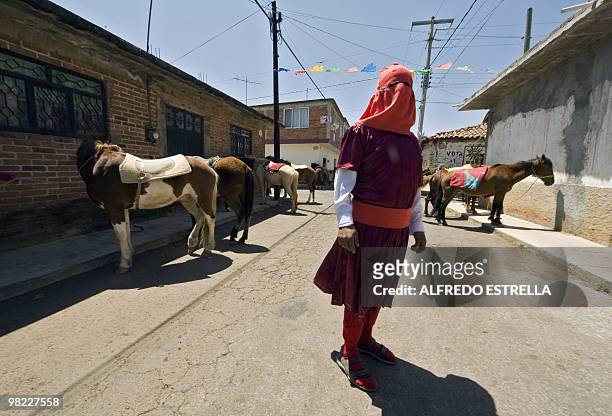 An actor performs the Via Crucis on April 1, 2010 in Tzintzuntzan community in Morelia, Mexico. The actors are called "Espias" , and ride around the...