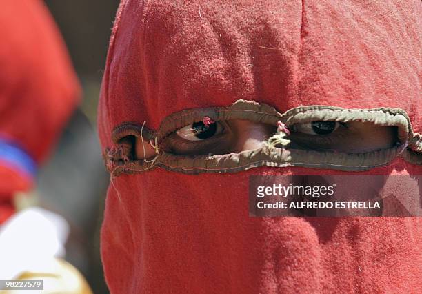 An actor performs the Via Crucis on April 1, 2010 in Tzintzuntzan community in Morelia, Mexico. The actors are called "Espias" , and ride around the...