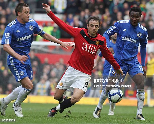 Dimitar Berbatov of Manchester United clashes with John Terry and John Obi Mikel of Chelsea during the FA Barclays Premier League match between...