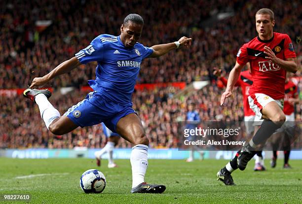 Didier Drogba of Chelsea scores his team's second goal during the Barclays Premier League match between Manchester United and Chelsea at Old Trafford...
