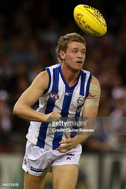 Lachlan Hansen of the Kangaroos handballs during the round two AFL match between the St Kilda Saints and the North Melbourne Kangaroos at Etihad...