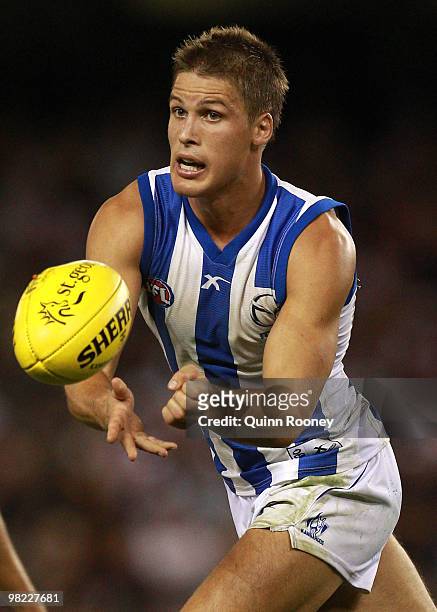 Andrew Swallow of the Kangaroos handballs during the round two AFL match between the St Kilda Saints and the North Melbourne Kangaroos at Etihad...