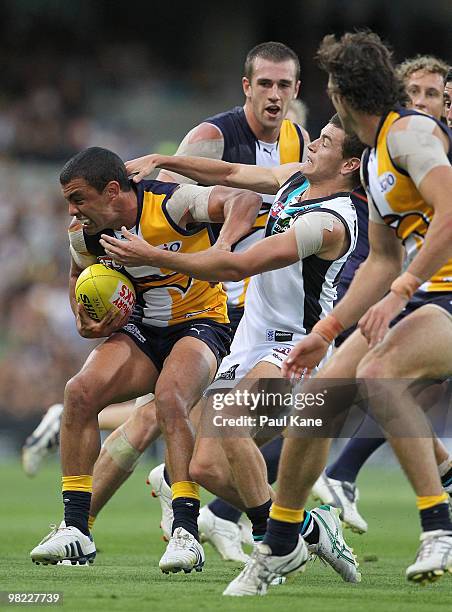 Daniel Kerr of the Eagles attempts to break from a tackle by Cameron Hitchcock of the Power during the round two AFL match between the West Coast...