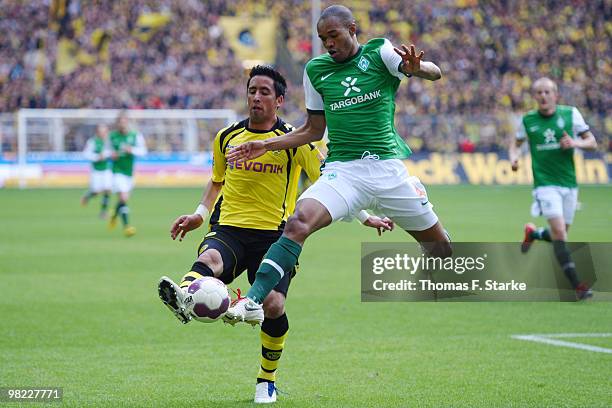 Naldo of Bremen and Lucas Barrios of Dortmund fight for the ball during the Bundesliga match between Borussia Dortmund and SV Werder Bremen at Signal...