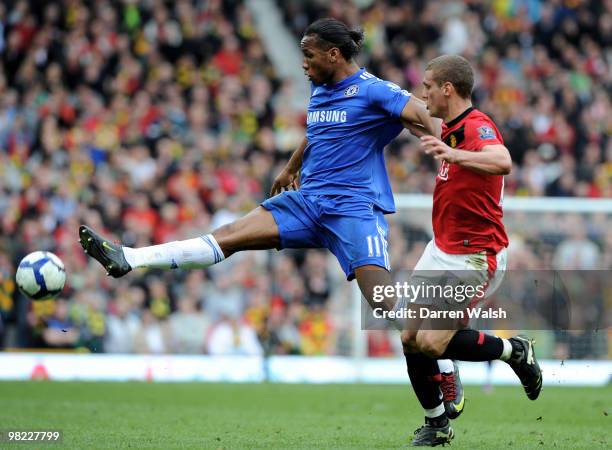 Didier Drogba of Chelsea beats Nemanja Vidic of Manchester United to the ball during the Barclays Premier League match between Manchester United and...