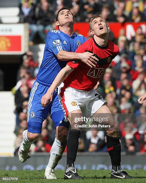 Darren Fletcher of Manchester United clashes with Frank Lampard of Chelsea during the FA Barclays Premier League match between Manchester United and...